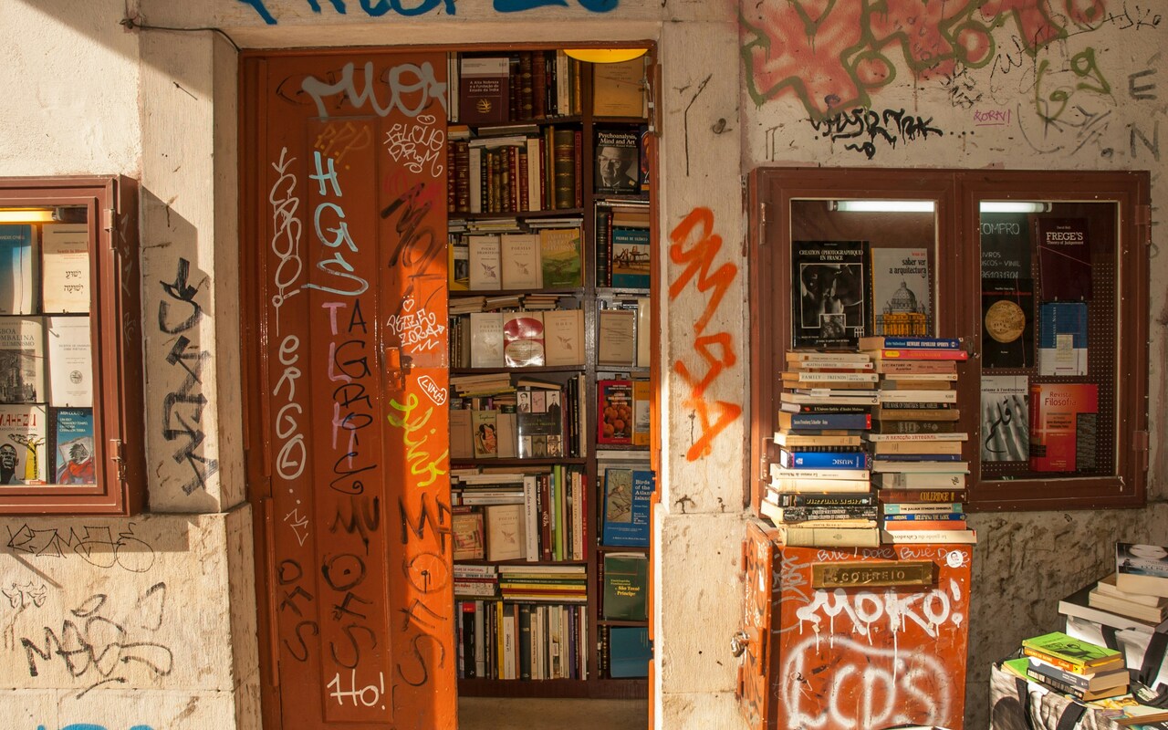 A photo of the entrance to a bookshop surrounded by graffiti
